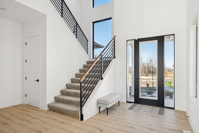 12745 Stutz Ct NE, Blaine, MN 55449 - foyer with wood finished floors, a high ceiling, stairs, and baseboards