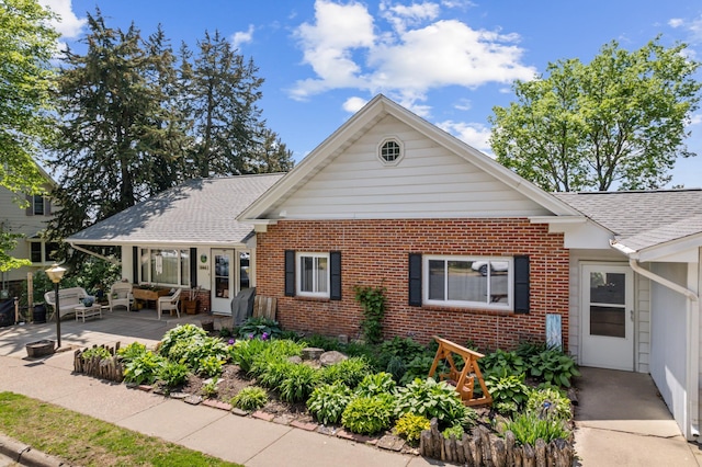 304 2nd St, Alma, WI 54610 - bungalow featuring brick siding, a shingled roof, a patio area, and an outdoor living space