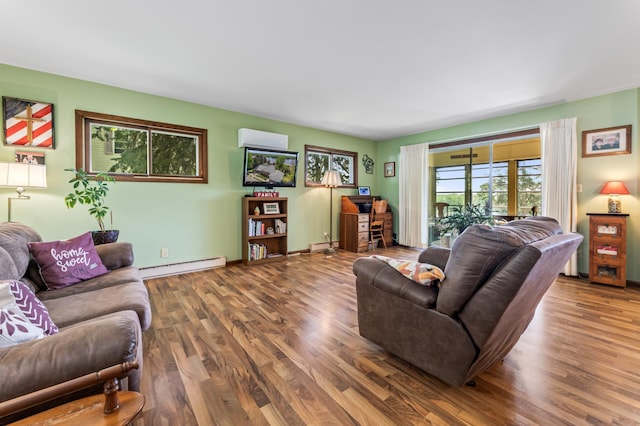 304 2nd St, Alma, WI 54610 - living room featuring a baseboard radiator, an AC wall unit, wood finished floors, baseboard heating, and baseboards