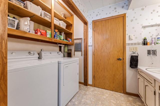 304 2nd St, Alma, WI 54610 - laundry room featuring washer and clothes dryer, cabinet space, wallpapered walls, and baseboards