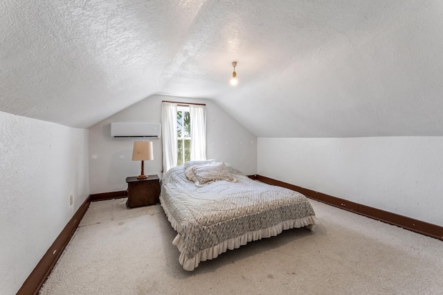 304 2nd St, Alma, WI 54610 - bedroom featuring a wall mounted AC, a textured ceiling, carpet flooring, lofted ceiling, and baseboards
