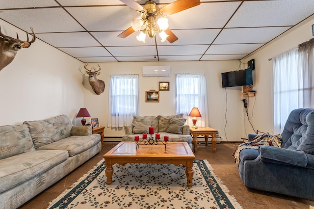 304 2nd St, Alma, WI 54610 - carpeted living area with a paneled ceiling, a wall unit AC, a baseboard radiator, ceiling fan, and baseboard heating