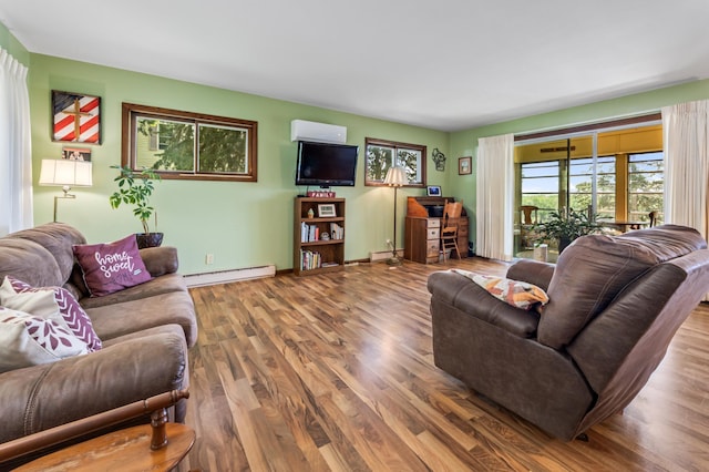 304 2nd St, Alma, WI 54610 - living room with a baseboard heating unit, wood finished floors, a baseboard radiator, and baseboards