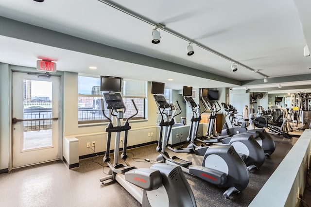 gym with healthy amount of natural light and baseboards