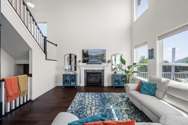 4118 San Vitero Ct, Victoria, MN 55318 - living area with a towering ceiling, wood finished floors, baseboards, and a glass covered fireplace