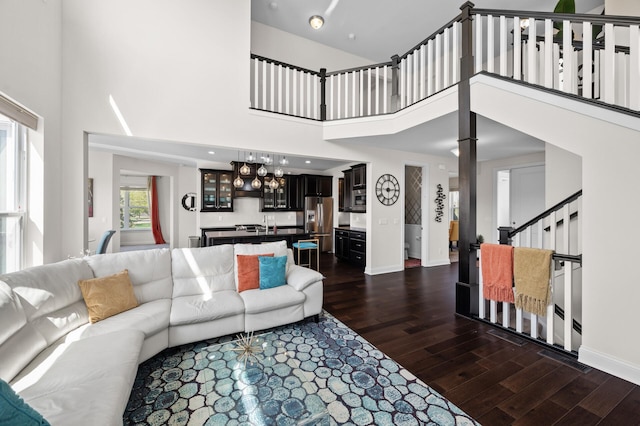 4118 San Vitero Ct, Victoria, MN 55318 - living area featuring dark wood-style flooring, a high ceiling, baseboards, and stairway