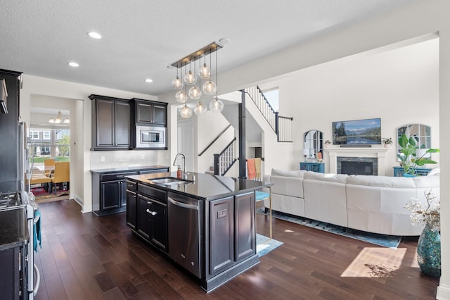 4118 San Vitero Ct, Victoria, MN 55318 - kitchen featuring a sink, stainless steel appliances, open floor plan, dark wood-style flooring, and a textured ceiling