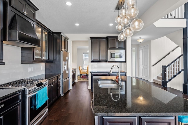 4118 San Vitero Ct, Victoria, MN 55318 - kitchen with stainless steel appliances, premium range hood, a sink, dark stone countertops, and recessed lighting