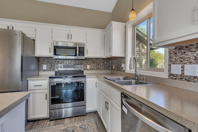7320 Deer Pass Dr, Centerville, MN 55038 - kitchen featuring stainless steel appliances, a sink, white cabinetry, pendant lighting, and light countertops
