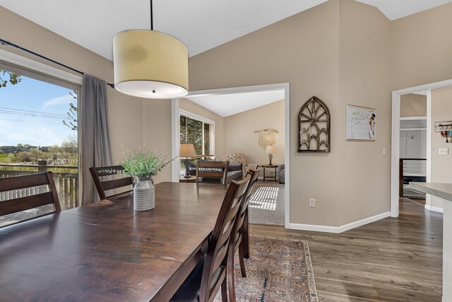 7320 Deer Pass Dr, Centerville, MN 55038 - dining space featuring wood finished floors, vaulted ceiling, and baseboards