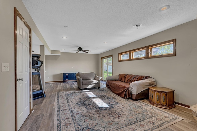 7320 Deer Pass Dr, Centerville, MN 55038 - living area with wood finished floors, baseboards, a textured ceiling, a ceiling fan, and recessed lighting