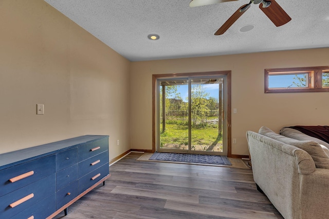 7320 Deer Pass Dr, Centerville, MN 55038 - unfurnished room featuring a textured ceiling, ceiling fan, dark wood-style floors, and baseboards