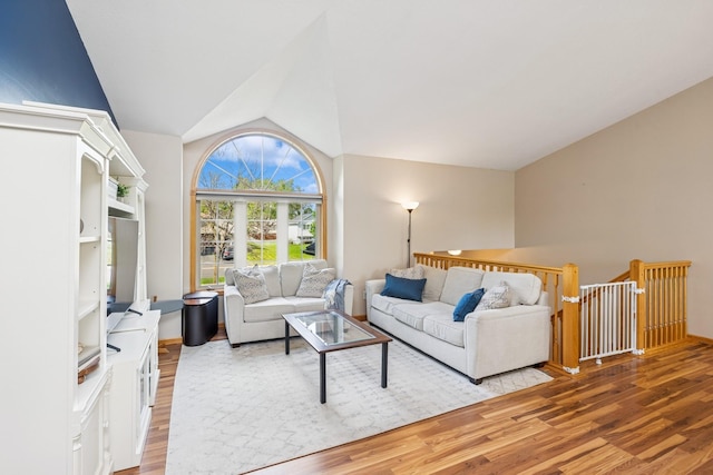 living area with lofted ceiling and light wood-style floors