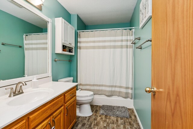full bathroom featuring wood finished floors, toilet, vanity, and shower / bathtub combination with curtain