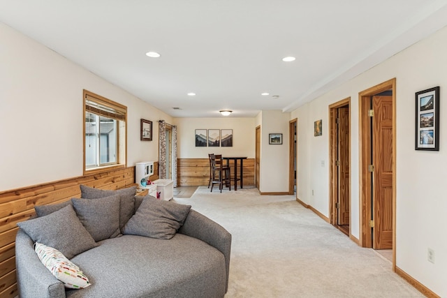 living room with recessed lighting, light carpet, and baseboards