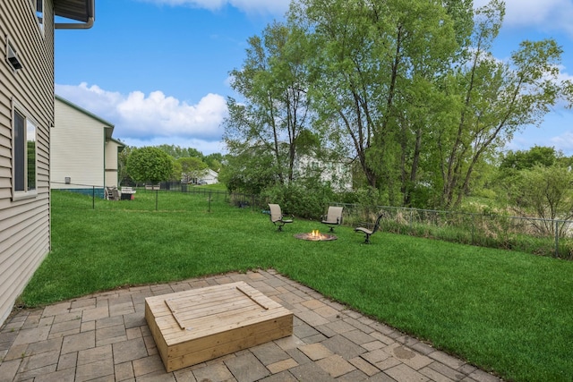 view of yard featuring an outdoor fire pit and a patio