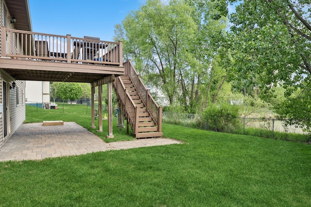 view of yard featuring a deck, a patio area, and stairway