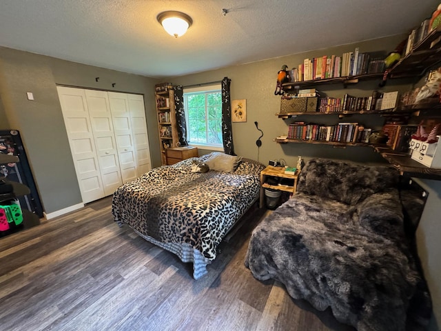 791 W Rd, Wright, MN 55798 - bedroom with wood finished floors, a textured ceiling, and a closet
