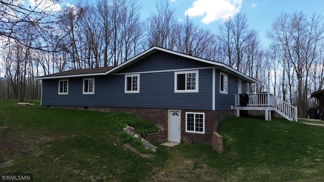 791 W Rd, Wright, MN 55798 - view of front of house with a front lawn, a wooden deck, and stairs