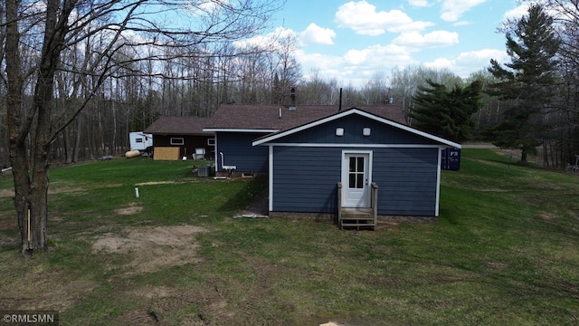 791 W Rd, Wright, MN 55798 - back of house featuring entry steps, central AC, a lawn, and a wooded view