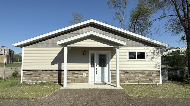 703 2nd St, Henning, MN 56551 - view of front of home featuring stone siding and fence