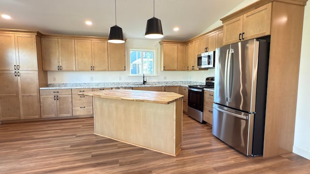 703 2nd St, Henning, MN 56551 - kitchen featuring stainless steel appliances, a sink, a center island, wood finished floors, and light brown cabinets