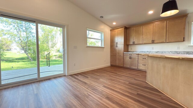 703 2nd St, Henning, MN 56551 - kitchen featuring wood finished floors, baseboards, recessed lighting, butcher block counters, and vaulted ceiling