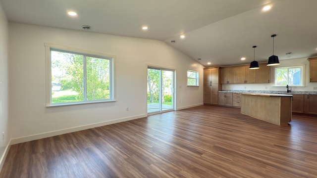 703 2nd St, Henning, MN 56551 - kitchen featuring a kitchen island, baseboards, lofted ceiling, light countertops, and dark wood finished floors