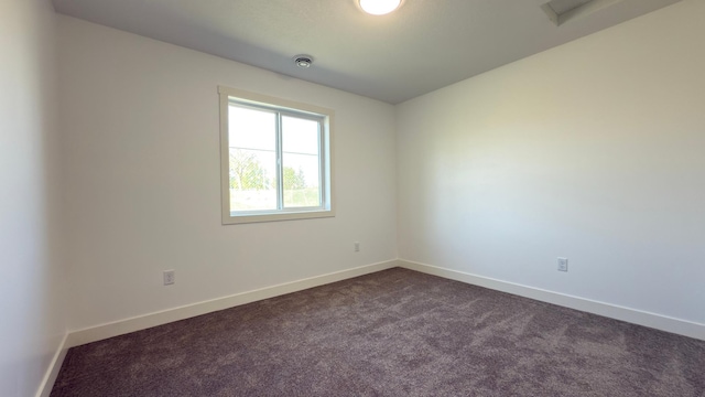 703 2nd St, Henning, MN 56551 - unfurnished room featuring dark colored carpet and baseboards