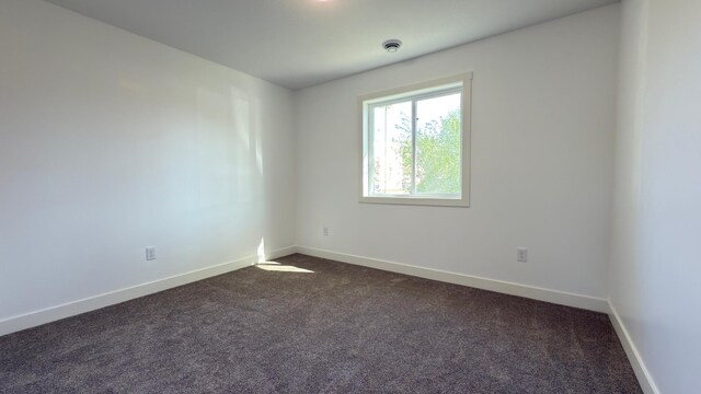 703 2nd St, Henning, MN 56551 - empty room featuring dark carpet and baseboards