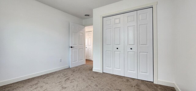703 2nd St, Henning, MN 56551 - unfurnished bedroom with carpet, baseboards, and a closet