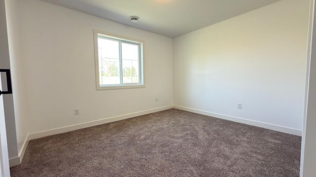 703 2nd St, Henning, MN 56551 - empty room with dark colored carpet and baseboards