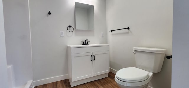 703 2nd St, Henning, MN 56551 - bathroom with wood finished floors, baseboards, and vanity