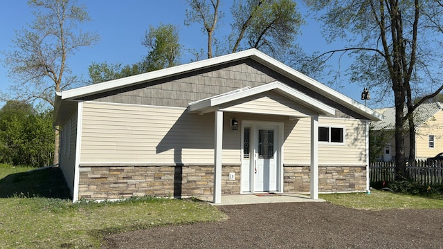 703 2nd St, Henning, MN 56551 - view of front facade with stone siding and fence