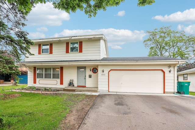 6012 Beard Ave N, Brooklyn Center, MN 55429 - view of front facade with driveway, an attached garage, and a front lawn