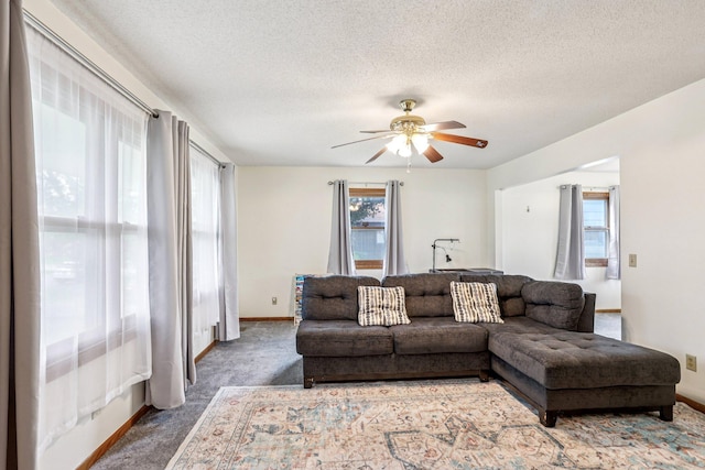 6012 Beard Ave N, Brooklyn Center, MN 55429 - living area featuring ceiling fan, a textured ceiling, baseboards, and carpet floors