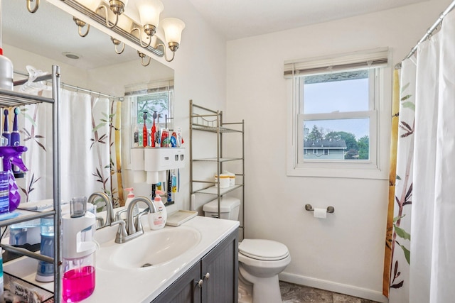 6012 Beard Ave N, Brooklyn Center, MN 55429 - bathroom with healthy amount of natural light, vanity, toilet, and baseboards