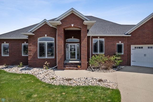 3914 21st Ave S, Moorhead, MN 56560 - traditional-style house with brick siding, a shingled roof, concrete driveway, and a garage