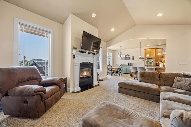 3914 21st Ave S, Moorhead, MN 56560 - carpeted living area with a glass covered fireplace, vaulted ceiling, a chandelier, recessed lighting, and baseboards