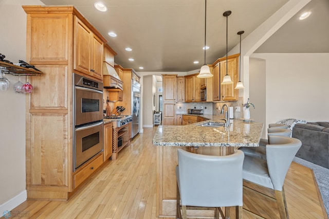3914 21st Ave S, Moorhead, MN 56560 - kitchen with a sink, stainless steel appliances, light stone countertops, a peninsula, and custom range hood
