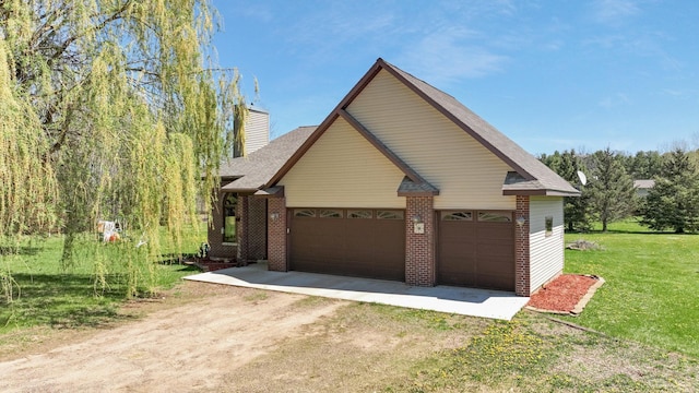 1513 19 1/4 St, Stanley Twp, WI 54822 - view of property exterior featuring brick siding, dirt driveway, a chimney, a yard, and an attached garage