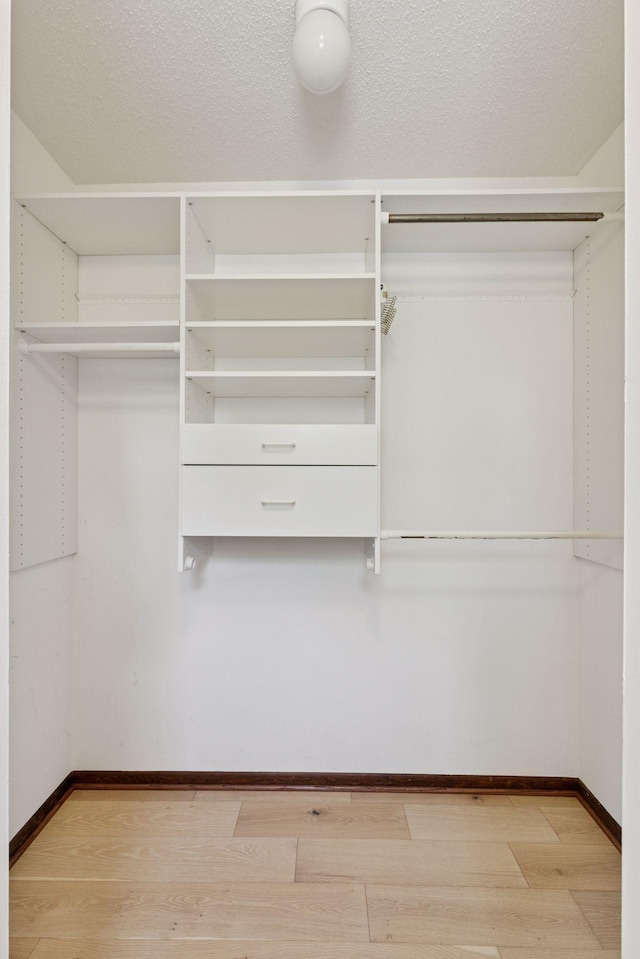 spacious closet with light wood finished floors