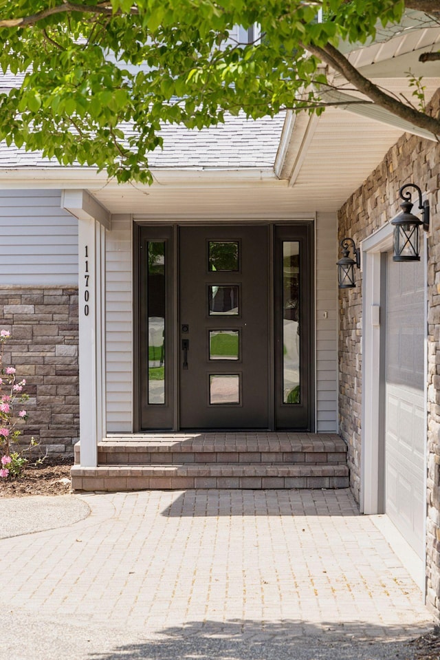 entrance to property with stone siding and a porch