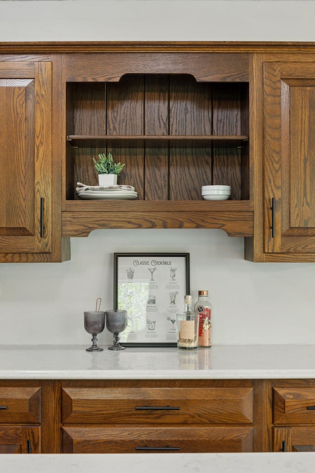 kitchen with brown cabinets, open shelves, and light countertops