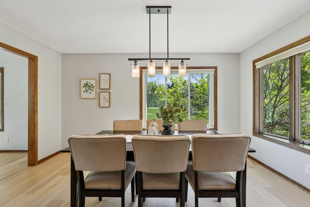 dining room with light wood-style flooring and baseboards