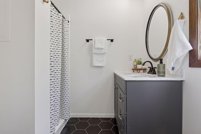 full bathroom with vanity, tile patterned flooring, a shower with curtain, and baseboards