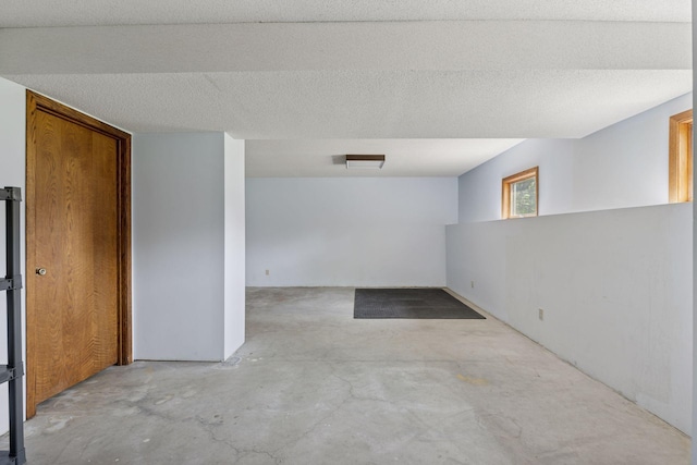 empty room with unfinished concrete flooring