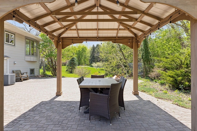 view of patio featuring outdoor dining space, a gazebo, and central AC unit