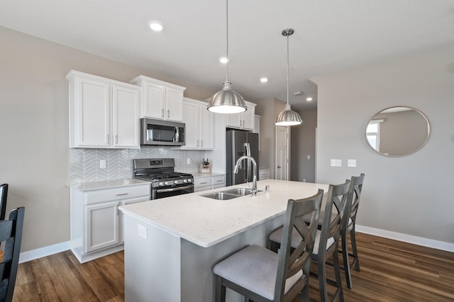 19000 72nd Pl N, Maple Grove, MN 55311 - kitchen featuring appliances with stainless steel finishes, a sink, dark wood finished floors, a center island with sink, and recessed lighting