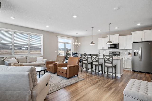 19000 72nd Pl N, Maple Grove, MN 55311 - living room with recessed lighting, a chandelier, and wood finished floors